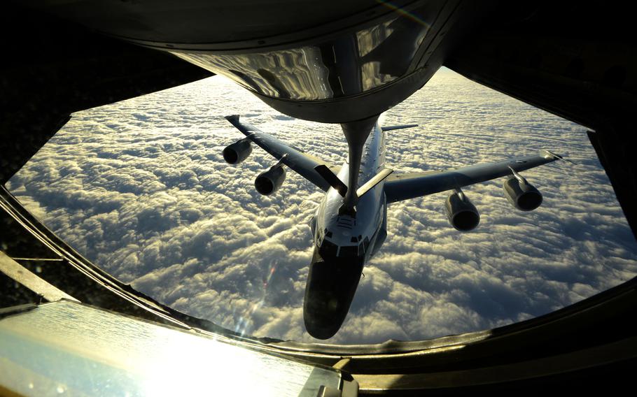 In this file photo from Dec. 24, 2014, a U.S. Air Force KC-135 Stratotanker from the 909th Air Refueling Squadron refuels a U.S. Air Force RC-135W Rivet Joint reconnaissance aircraft from the 82nd Intelligence Squadron near Okinawa, Japan.
