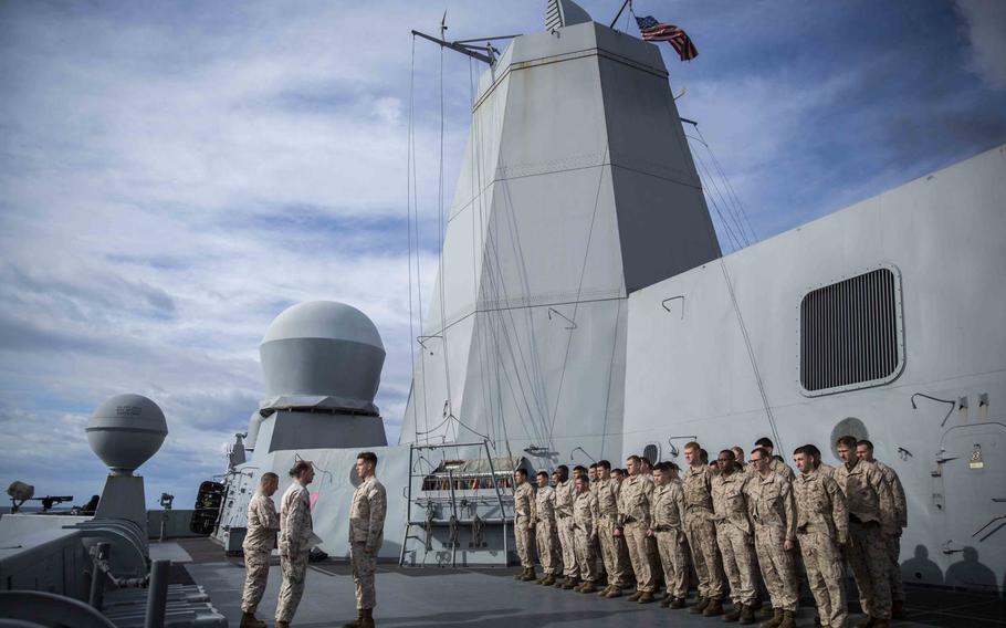 Marines with Combat Logistics Battalion 24, 24th Marine Expeditionary Unit, stand in formation during a promotion ceremony aboard the USS New York, at sea, Jan. 10, 2015. The 24th MEU and Iwo Jima Amphibious Ready Group are conducting naval operations in the U.S. 6th Fleet area of operations in support of U.S. national security interests in Europe.