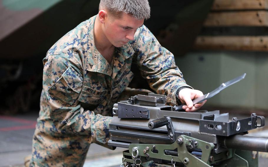 Lance Cpl. Matthew Millward, a machine gunner with weapons platoon,  Company E, Battalion Landing Team 2nd Battalion, 1st Marines, 11th Marine Expeditionary Unit, from Rescue, Calif., disassembles and reassembles an Mk 19 grenade launcher in the well deck of the dock landing ship USS Comstock, in preparation for an advanced machine gun course, Jan. 13, 2015. The 11th MEU is deployed with the Makin Island Amphibious Ready Group (ARG) as a theater reserve and crisis response force throughout the U.S. 5th Fleet and U.S. 7th Fleet areas of responsibility.