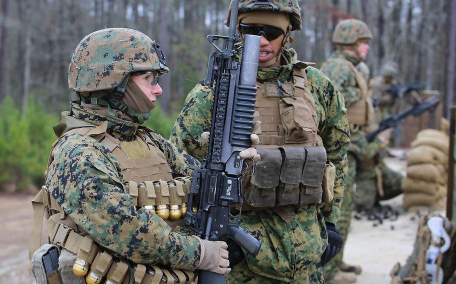 Sgt. Radmila M. Allen, left, team leader with 3rd Platoon, Company A, Ground Combat Element Integrated Task Force, talks with Sgt. Jesus Garcia, squad leader and position safety officer, about the course of fire for the M203 live-fire at the Verona Loop training area, near Marine Corps Base Camp Lejeune, N.C., Jan. 14, 2015.