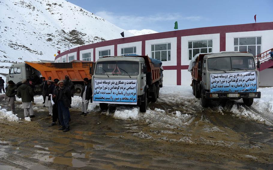 Trucks full of emergency supplies sit outside a stadium in Panjshir province, Afghanistan, on Saturday, Feb. 28, 2015. Emergency crews and security forces used the area to stage equipment and supplies before loading them onto helicopters for delivery.