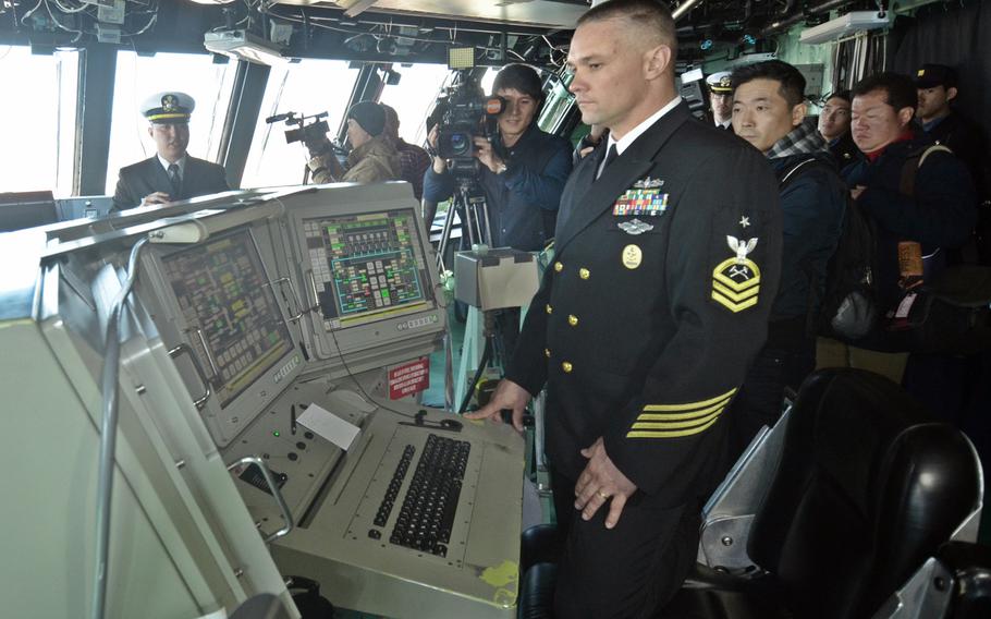 Command Senior Chief Petty Officer Craig Cole checks the electric and propulsion systems via a touchscreen aboard the bridge of the littoral combat ship USS Fort Worth on Saturday in Busan, South Korea.