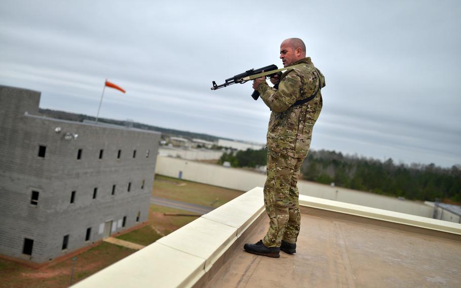 Nathan Cumminskey, an employee of the Guardian Center of Georgia, fires blank rounds at students during a training event at Global Dragon Deployment For Training on on March 13, 2015.
