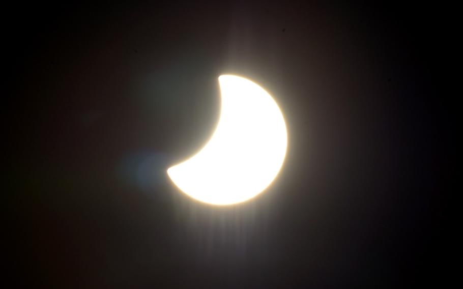 The moon moves across the face of the sun at 11:12 a.m. towards the end of a partial solar eclipse over Kaiserslautern, Germany, on the first day of spring, Friday, March 20, 2015.