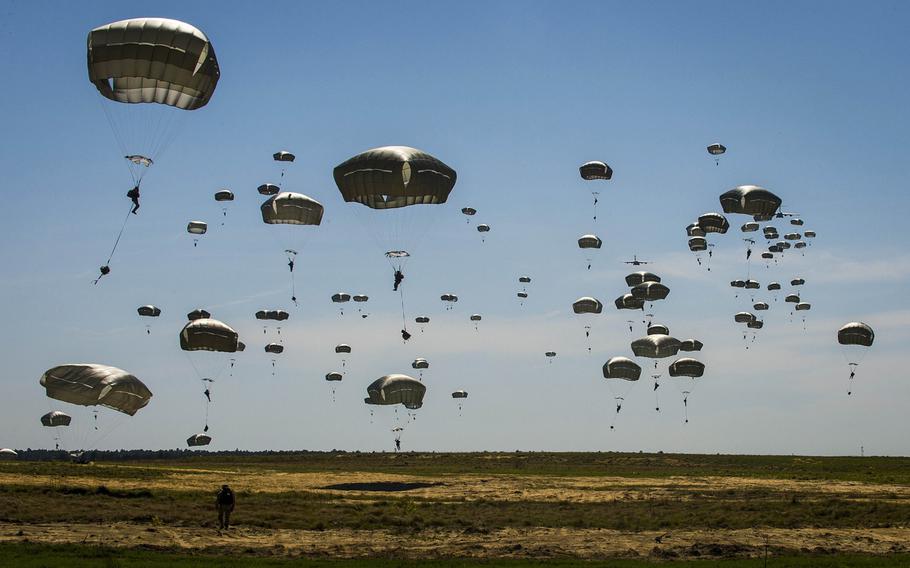 U.S. soldiers from the 82nd Airborne Division make their way to ground after static-line jumps from U.S Air National Guard C-17 Globemaster IIIs at the Sicily Drop Zone in Fort Bragg, N.C., on April 11, 2015.