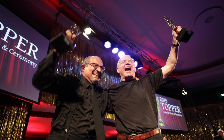 Tom Navo, left, and David Hambleton Schwab celebrate their tie for best actor in a play at the annual U.S. Army Europe Topper Awards ceremony Saturday, April 25, 2015, in Kaiserslautern, Germany. Both men portrayed jurors in Baumholder's production of the play ''12 Angry Men.''