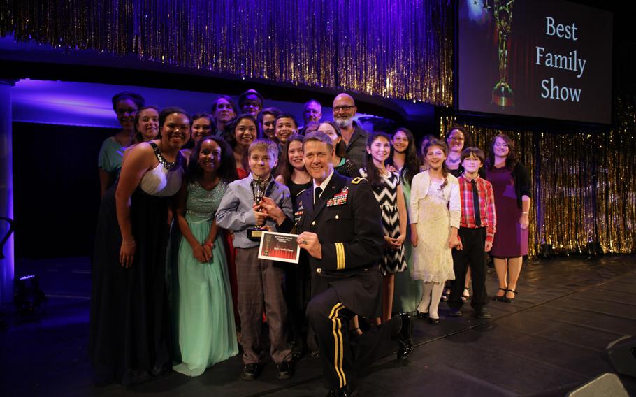 Maj. Gen. John O'Connor, commander of the 21st Theater Sustainment Command, poses with the cast of ''Shrek Jr.,'' winner of the best family show in U.S. Army Europe's 2015 Tournament of Plays. The show was produced by the SHAPE Players? Performing Arts School.