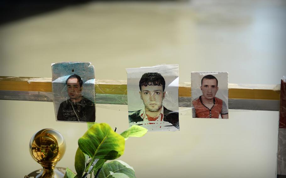 Photos of victims are placed at a memorial for hundreds of young Iraqi men executed by the Islamic State along the Tigris River in Tikrit.