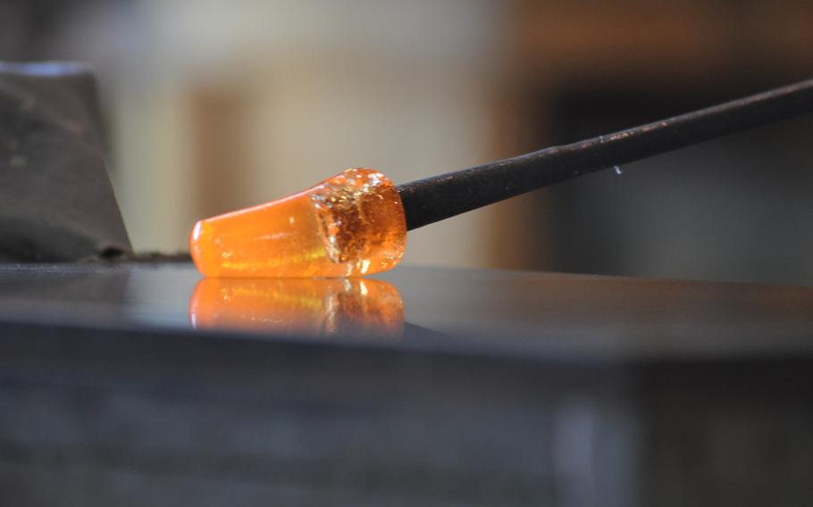 A molten hot piece of glass starts to take shape at the Guarnieri glass factory on Murano in Venice, Italy.