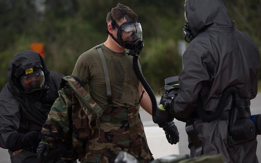 An explosive ordnance disposal technician undergoes the decontamination process after leak, seal, package and decontamination training April 21, 2015, at the gas chamber on Camp Hansen, Okinawa.