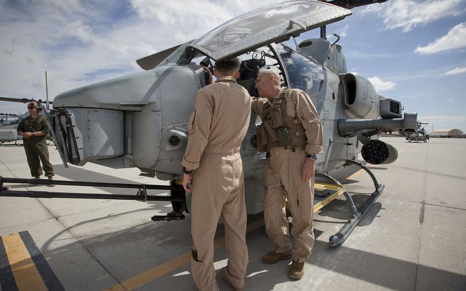 Maj. Stephen Piantanida, left, briefs the Assistant Commandant of the U.S. Marine Corps, Gen. John M. Paxton, Jr., on the weapons capabilities of the AH-1W, before a flight in support of the final exercise at Marine Corps Air Station Yuma, Ariz., 25 April 2015.