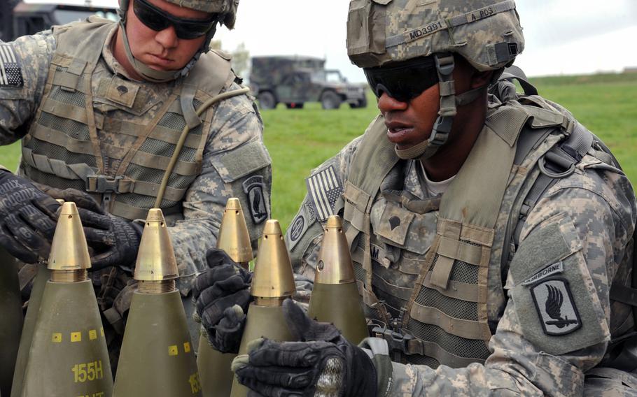 Spc. Marquis Durham, right, and Spc. Robert Johnson, paratroopers assigned to the 173rd Airborne Brigade, prepare 155 mm rounds for firing with M777A2 Howitzers during a live fire exercise at the 7th Army Joint Multinational Training Command's Grafenwoehr Training Area, Germany, April 30, 2015.