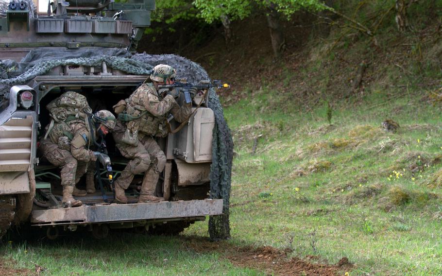 Troops with the 3rd Infantry Division prepare to dismount from their Bradley fighting vehicle to perform a security and reconnaissance mission during a situational training exercise in Hohenfels Training Area, Germany, on May 5, 2015.