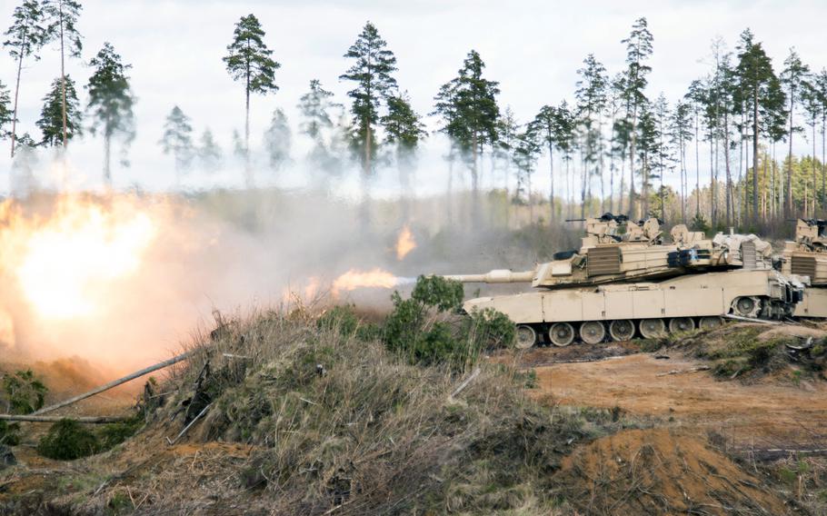 The blast of an U.S. Army M1A2 Abrams Main Battle Tank firing the main gun sends up a cloud of flame and smoke during a live-fire exercise in Estonia on April 30, 2015.