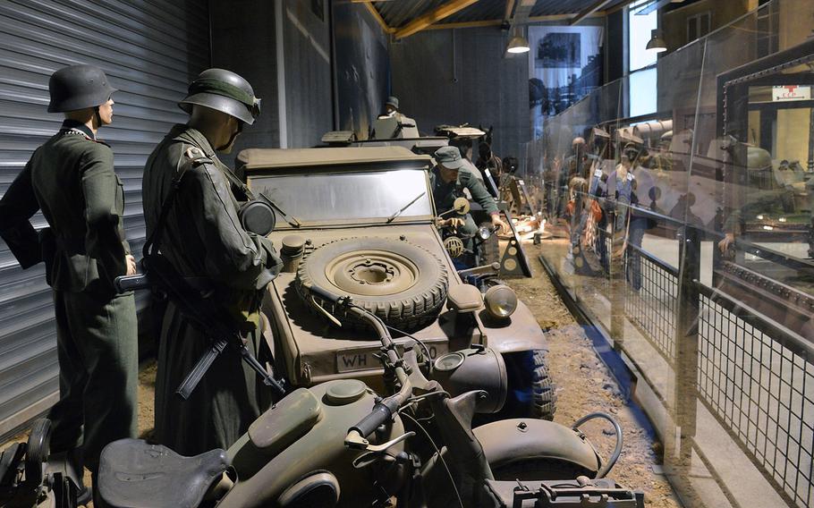 A display at the Overlord Museum in Colleville-sur-Mer, France, depicts German soldiers standing around a Kuebelwagen, a jeep-like vehicle made by Volkswagen.