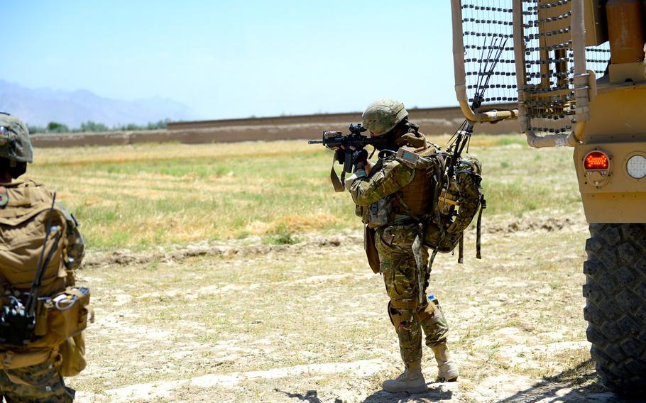 A member of the 43th Georgian Light Infantry Battalion scans the perimeter for threats during a force protection patrol outside Bagram Air Field in Parwan province, June 10, 2015.