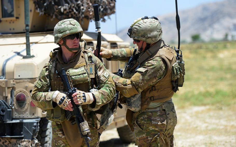 Georgian troops attached to 4th Light Infantry Battalion check communications gear before heading out on a June 10, 2015, force protection patrol outside Bagram Air Field in Parwan province.