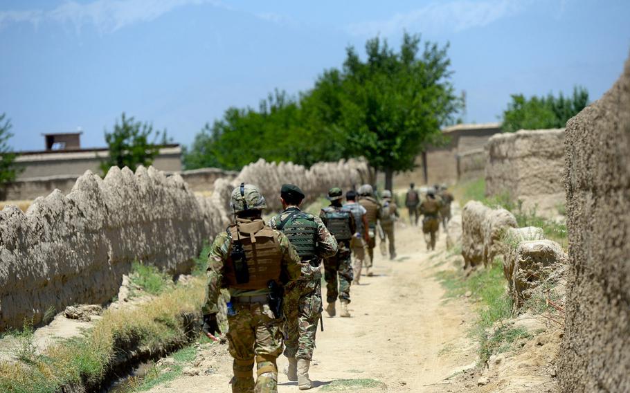 American, Afghan and Georgian troops head into a village during a June 10, 2015, security patrol outside Bagram Air Field in Parwan province, central Afghanistan.