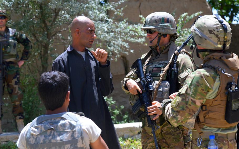 Master Sgt. Gogita Getia, 43rd Georgian Light Infantry Battalion, questions an Afghan local on the whereabouts of several "persons of interest" during a June 10, 2015, joint security patrol with U.S. forces in Parwan province, central Afghanistan.