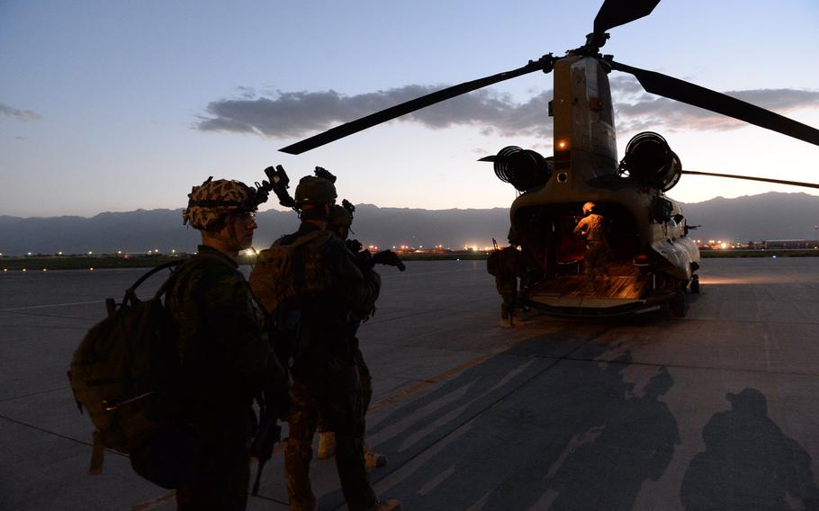 American and Czech troops wait to board an U.S. Army Chinook at Bagram Air Field during a June 3, 2015, nighttime reconnaissance patrol in Parwan province, central Afghanistan.