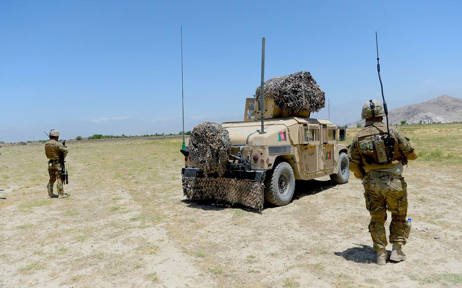 Georgian troops from the 43rd Light Infantry Battalion flank an Afghan Army Humvee during a June 10, 2015, security patrol outside Bagram Air Field in Parwan province.