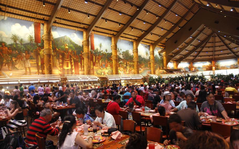 Diners at Island Buffet eat below huge murals depicting life in Polynesia.