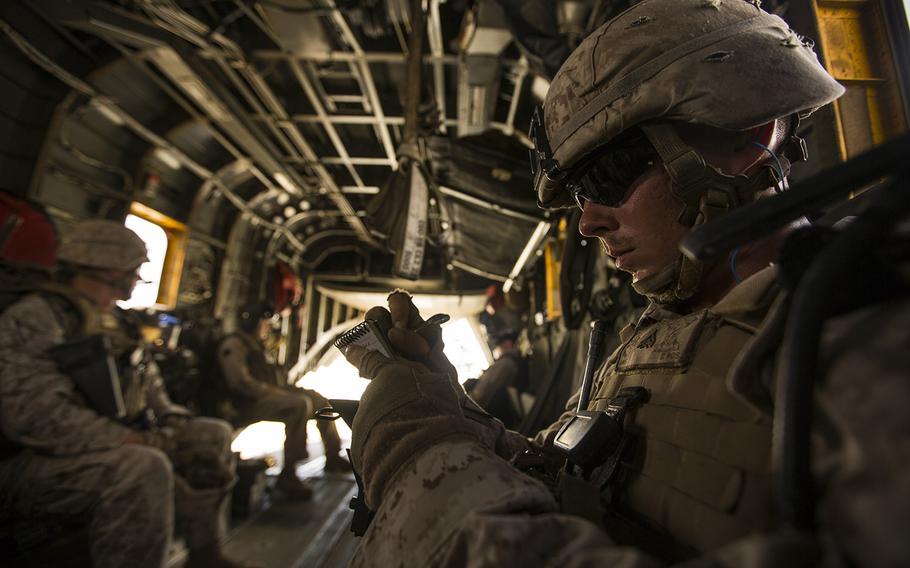 U.S. Marine Corps Cpl. Christopher Macelveen goes over instructions for his squad aboard a CH-53E Super Stallion, before conducting a tactical recovery of aircraft and personnel mission at Twentynine Palms, Calif., Aug. 1, 2015.