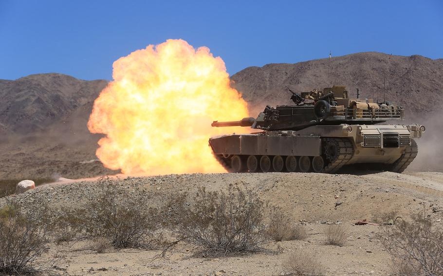 An M1A1 Abrams Main Battle Tank crew with Company A, 4th Tank Battalion, fires its 120mm main gun during the company?s pre-qualification tank gunnery at Twentynine Palms, Calif., Aug. 4, 2015.
