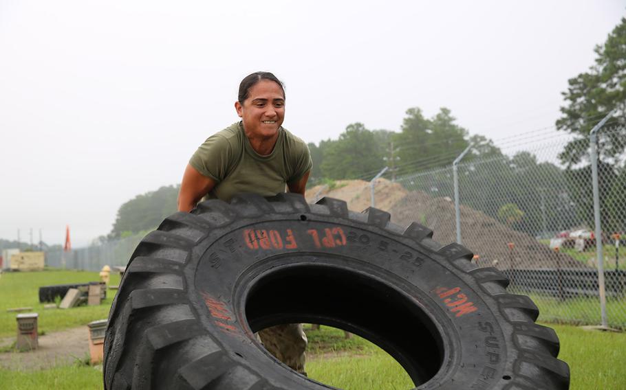 Staff Sgt. Marissa Grudowski executes a tire flip aboard Marine Corps Air Station Beaufort, S.C., on Aug. 4, 2015, to prepare for the Ultimate Tactical Athlete competition.