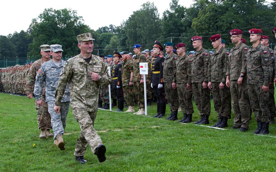 Ukrainian and U.S. officers review troops in formation during a ceremony marking the start of Rapid Trident 2015, a long-standing cooperative training exercise focused on stability and peacekeeping operations, in Yavoriv, Ukraine, July 20, 2015.