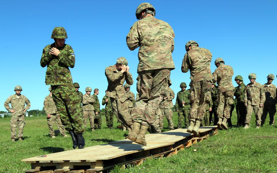 Soldiers with 2nd Battalion, 503rd Infantry Regiment, 173rd Airborne Brigade, join their Estonian counterparts while practicing landing procedures in preparation for a joint airborne jump at Tapa Army Base, Estonia, July 21, 2015, as part of operation Atlantic Resolve.