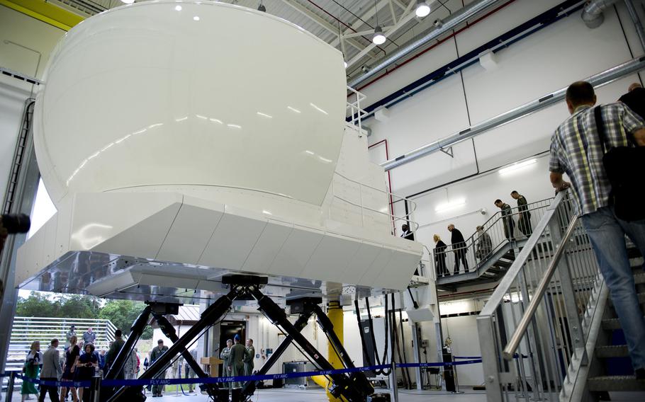 Visitors take a tour of the new C-130J simulator at Ramstein Air Base, Germany, Monday, Aug. 24, 2015. Ramstein is the first U.S. Air Force base overseas to employ a C-130J simulator for its pilots and aircrews. The simulator is expected to save crews time and money, cutting back on fuel costs for training missions and travel time to the States for simulator training.
