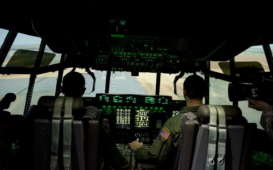 Maj. Devon Cummings, an 86th Operational Support Squadron operations officer, right, and Capt. Fred Backhus, a C-130J Super Hercules pilot, operate the new C-130J simulator at Ramstein Air Base, Germany, Monday, Aug. 24, 2015. The Maintenance and Aircrew Training System allows aircrew and maintainers to train on a variety of scenarios that could be potentially costly, or dangerous, in real aircraft.