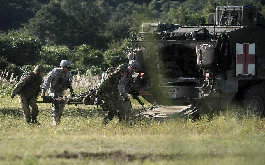Medics from 1st Stryker Brigade Combat Team, 25th Infantry Division and the Japan Ground Self-Defense Force's 6th Division recover a simulated casualty Tuesday, Sept. 15, 2015, during an exercise at Ojojihara Maneuver Area in northeast Japan.
