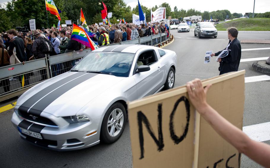 Traffic makes its way through a demonstration outside Ramstein Air Base, Germany, on Saturday, Sept. 26, 2015. Several hundred people gathered to protest military activities at the base.