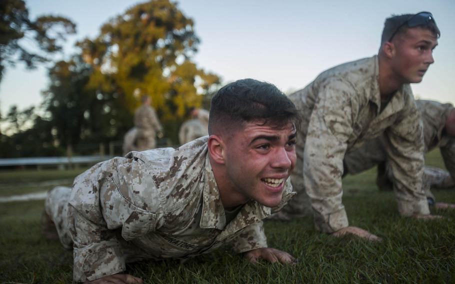 Pfc. Anthony Muratore, scout sniper screener candidate from 3rd Battalion, 6th Marine Regiment, conducts a max set of push-ups after completing a 1.5 mile ruck run at Camp Lejeune, N.C., Oct. 20, 2015.