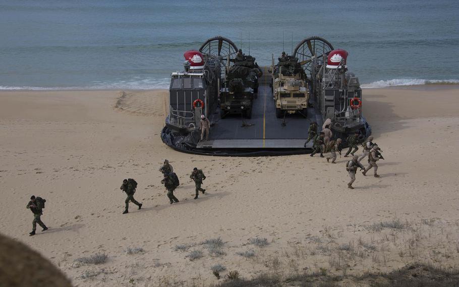 U.S. and Portuguese Marines from the Kearsarge Amphibious Ready Group, offload from an Landing Craft Air Cushion on Pinheiro Da Cruz beach while participating in a combined amphibious assault exercise as part of Trident Juncture 15, Oct. 20, 2015.