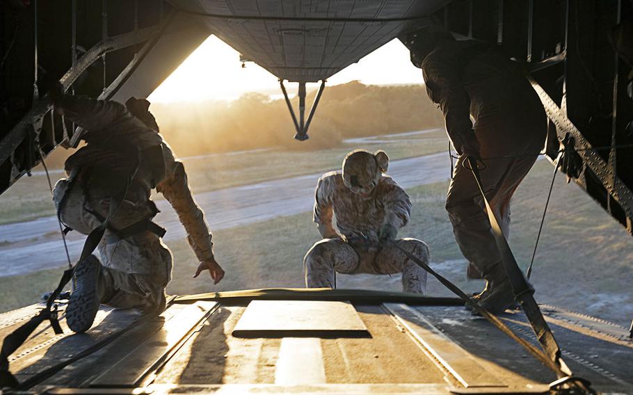 A U.S. Marine with 2nd Reconnaissance Battalion, rappels out the back of a CH-53E Super Stallion assigned to Marine Heavy Helicopter Squadron (HMH) 366, during rappelling training above Marine Corps Base Camp Lejeune, N.C., Oct. 20, 2015.