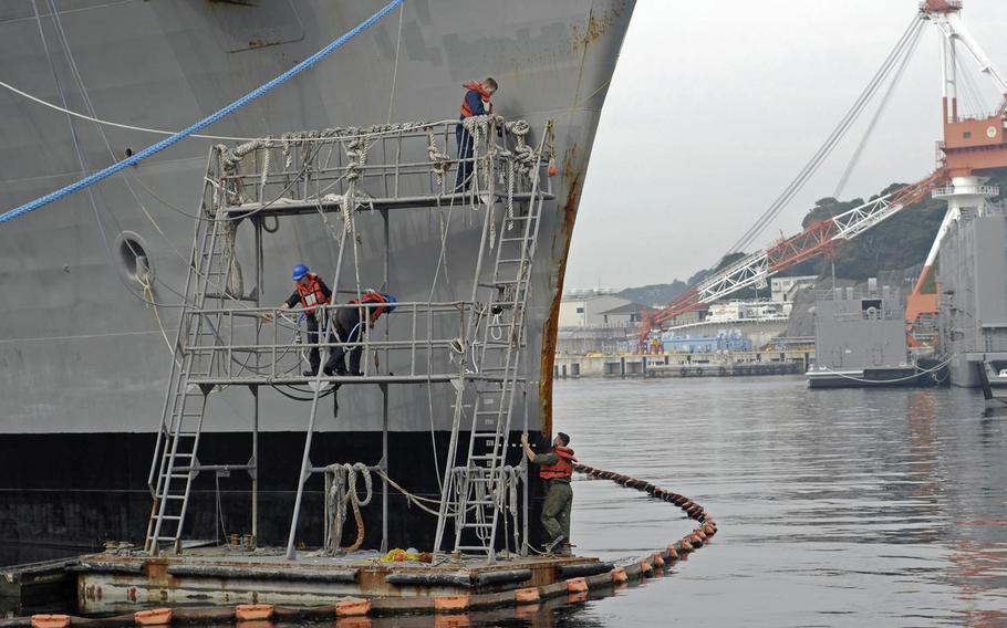 Sailors attached to the U.S. 7th Fleet flagship USS Blue Ridge conduct repairs to the starboard bow of the ship Oct. 20, 2015.