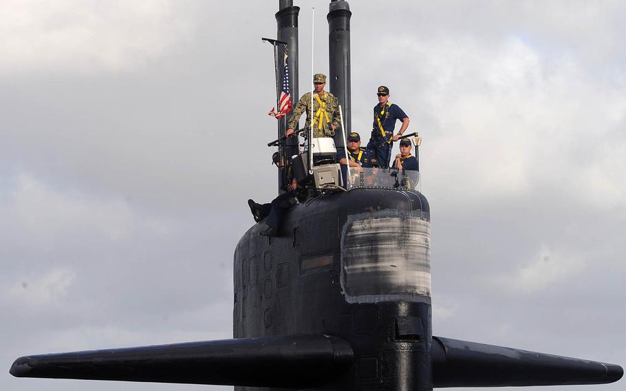 Cmdr. Donald Tenney, right, commanding officer of the Los Angeles-class fast-attack submarine USS Albuquerque, stands on the bridge as the boat prepares to depart San Diego for the final time Oct. 21, 2015. Albuquerque held an inactivation ceremony Oct. 16 at Naval Base Point Loma, marking the submarine's final public event celebrating more than 32 years of Naval service.