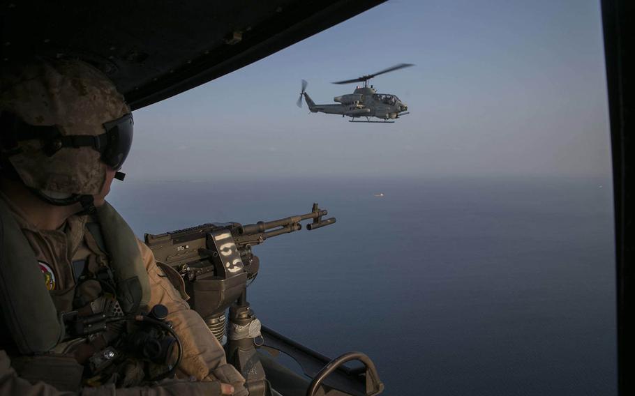 Cpl. Joseph Knolton looks at a Bell AH-1 Super Cobra while returning from recovering a simulated downed aircraft Oct. 28, 2015, during Blue Chromite 16 off the coast of Okinawa, Japan.