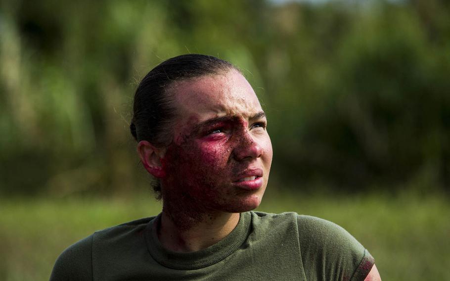Lance Cpl. Kelcey E. Kelly acts as the victim of a simulated improvised explosive device during Blue Chromite 2016, at Central Training Area, Okinawa, Japan, Oct. 29, 2015.