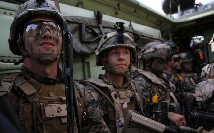 Marine Cpl. Daniel Ferrebee, left, a squad leader in 1st Platoon, Charlie Company, 1st Battalion, 2nd Marine Regiment, waits with his squad to move inland after making landfall in an amphibious assault vehicle Oct. 29, 2015, during exercise Blue Chromite 16. Blue Chromite 16 featured two amphibious landings, a regimental air assault, a support-by-fire exercise, a mass-casualty evacuation drill and unit-level training.