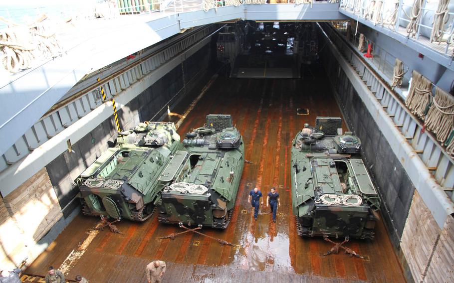 Marine amphibious assault vehicles, bottom, and Navy Landing Craft Air Cushions, top, sit in the well deck of the USS Germantown, an amphibious dock landing ship, last week during exercise Blue Chromite 16 in Okinawa, Japan.