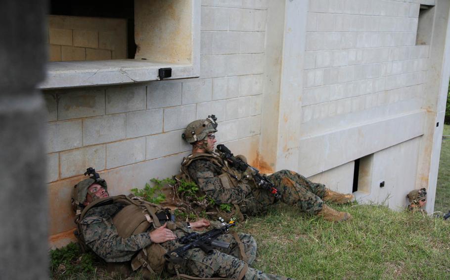 Two Marine casualties from 1st Platoon, Charlie Company, 1st Battalion, 2nd Marine Regiment wait to be evacuated from Okinawa's Combat Town Oct. 29, 2015, during exercise Blue Chromite 16.