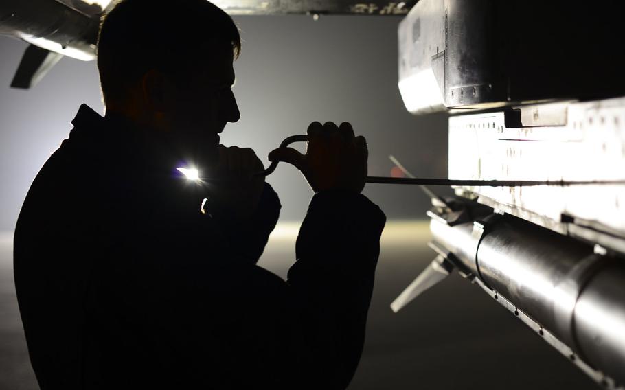 U.S. Air Force Senior Airman John Del Guidice, 31st Maintenance Squadron weapons load team member, secures a munition onto an F-16 Fighting Falcon, Nov. 9, 2015, at Aviano Air Base, Italy.