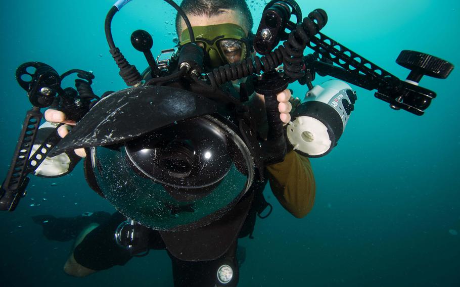 Mass Communication Specialist 2nd Class Sean Furey, assigned to Expeditionary Combat Camera, conducts underwater photo training off the coast of Guantanamo Bay, Cuba, Nov. 16, 2015.