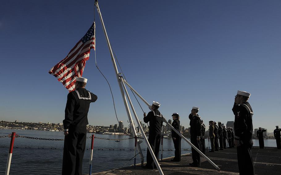 Aviation Ordnanceman Airman Noe Mendoza, from Harlingen, Texas, raises the American flag aboard the aircraft carrier USS Theodore Roosevelt on Nov. 23, 2015. The Theodore Roosevelt arrived at its new homeport of San Diego after completing an eight-month around-the-world deployment.