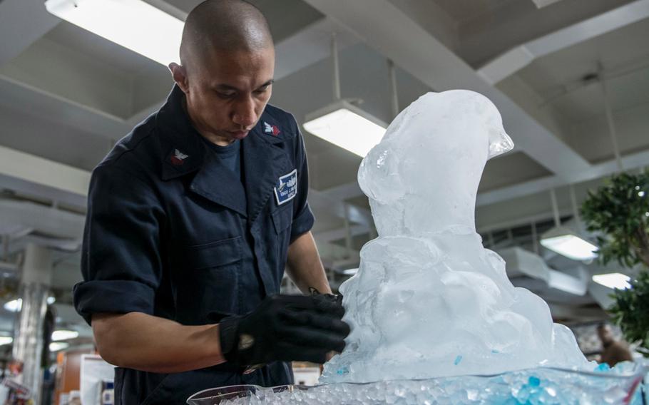 Culinary Specialist 1st Class Jerry Encomienda from Orlando, Fla., prepares an ice mold for Thanksgiving dinner aboard the U.S. Navy's only forward-deployed aircraft carrier, USS Ronald Reagan, on Nov. 26, 2015.