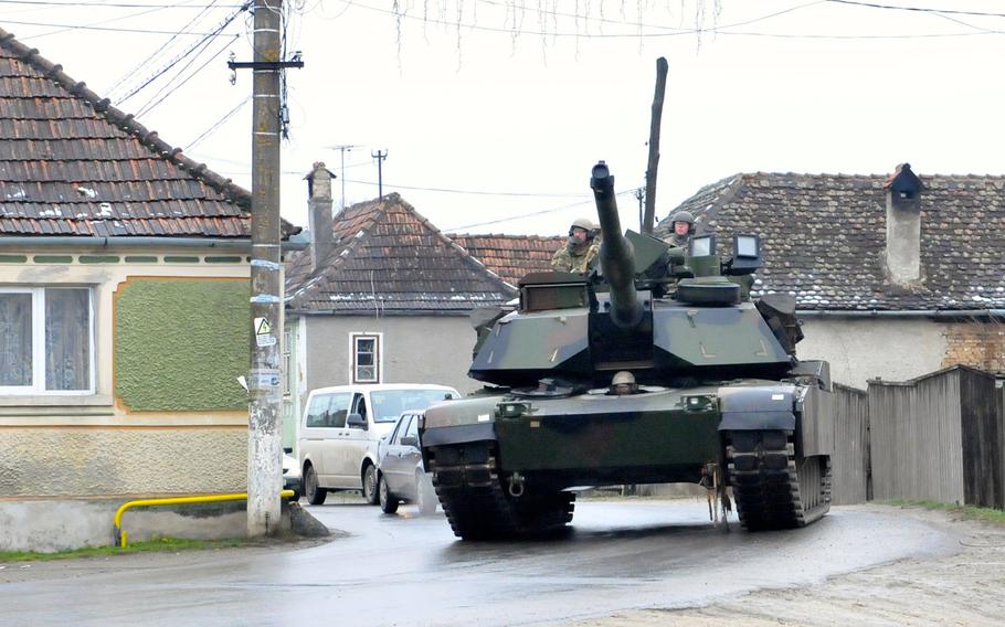 An M1A2 Abrams rounds a street corner in Cincu, Romania, on Nov. 24, 2015. The tank was part of an exercise to validate that bridges and a dam in the area could withstand the weight of the vehicle. The equipment from 5-7 CAV is currently in Romania as part of Operation Atlantic Resolve.